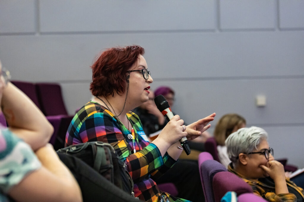 Attendee engaging in a lively Q&A