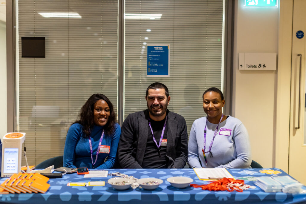 Smiling volunteers at the registration desk