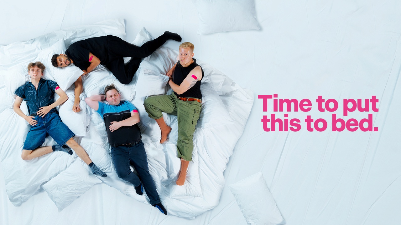 Four people lying on a large white bed with pink plasters on their arms, beside bold pink text that reads “Time to put this to bed.